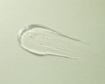 Close-up of a smear of clear gel on a light green background