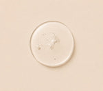 Close-up of bubble of serum on a beige background