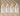 Four bottles of VISH Niacinamide Serum on a beige background